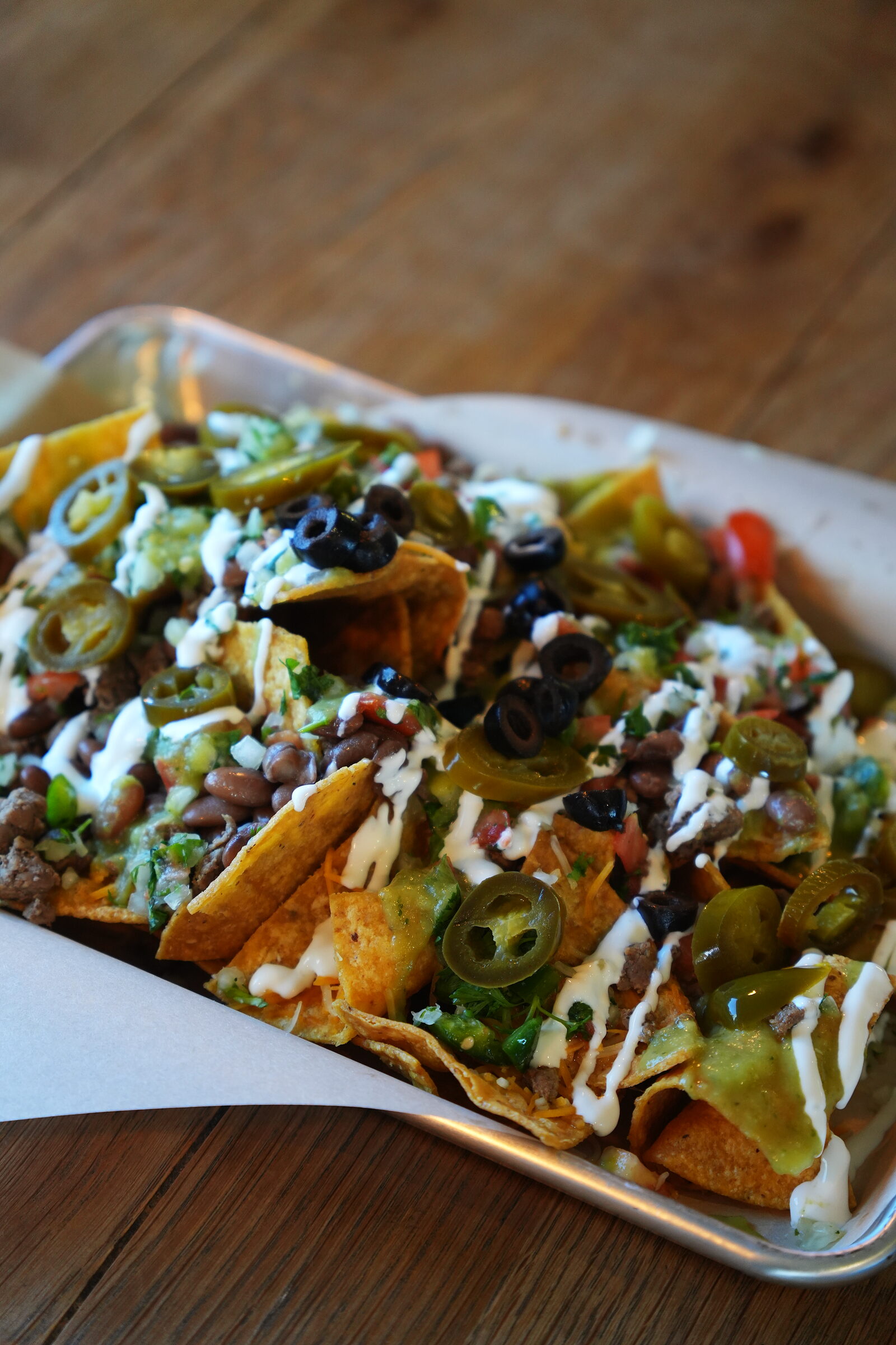 Loaded chips with beans, cheese, jalapeños and crema